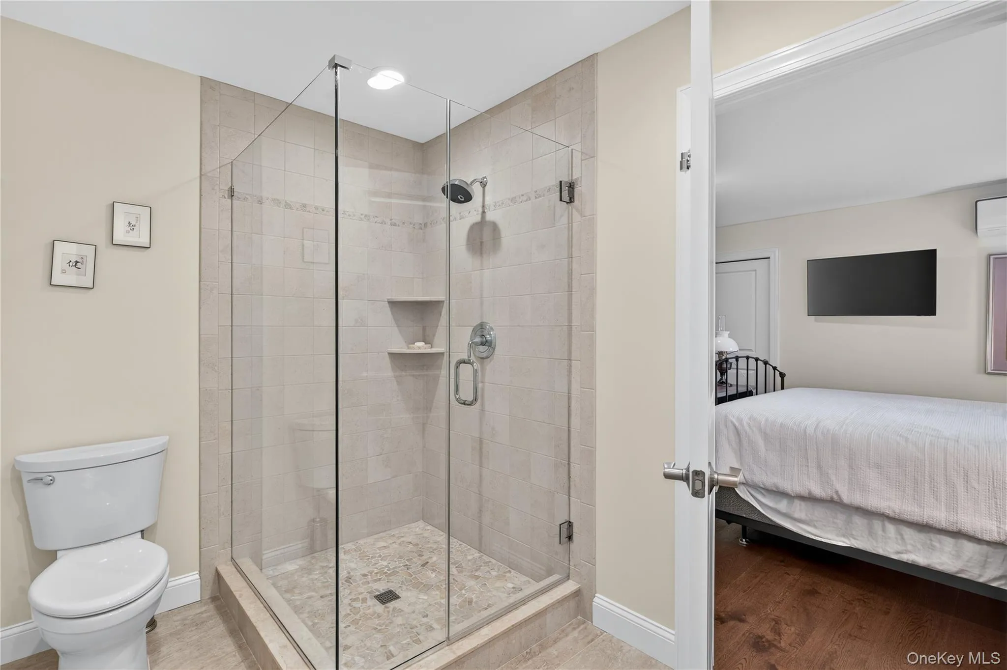 Stylish tile and glass hall bath with double vanity and large shower. Stylish tile and glass hall bath with double vanity and large shower.