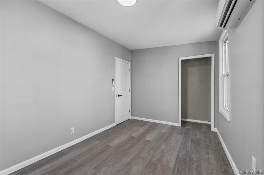 Neutral gray walls complement wood-finish flooring Neutral gray walls complement wood-finish flooring