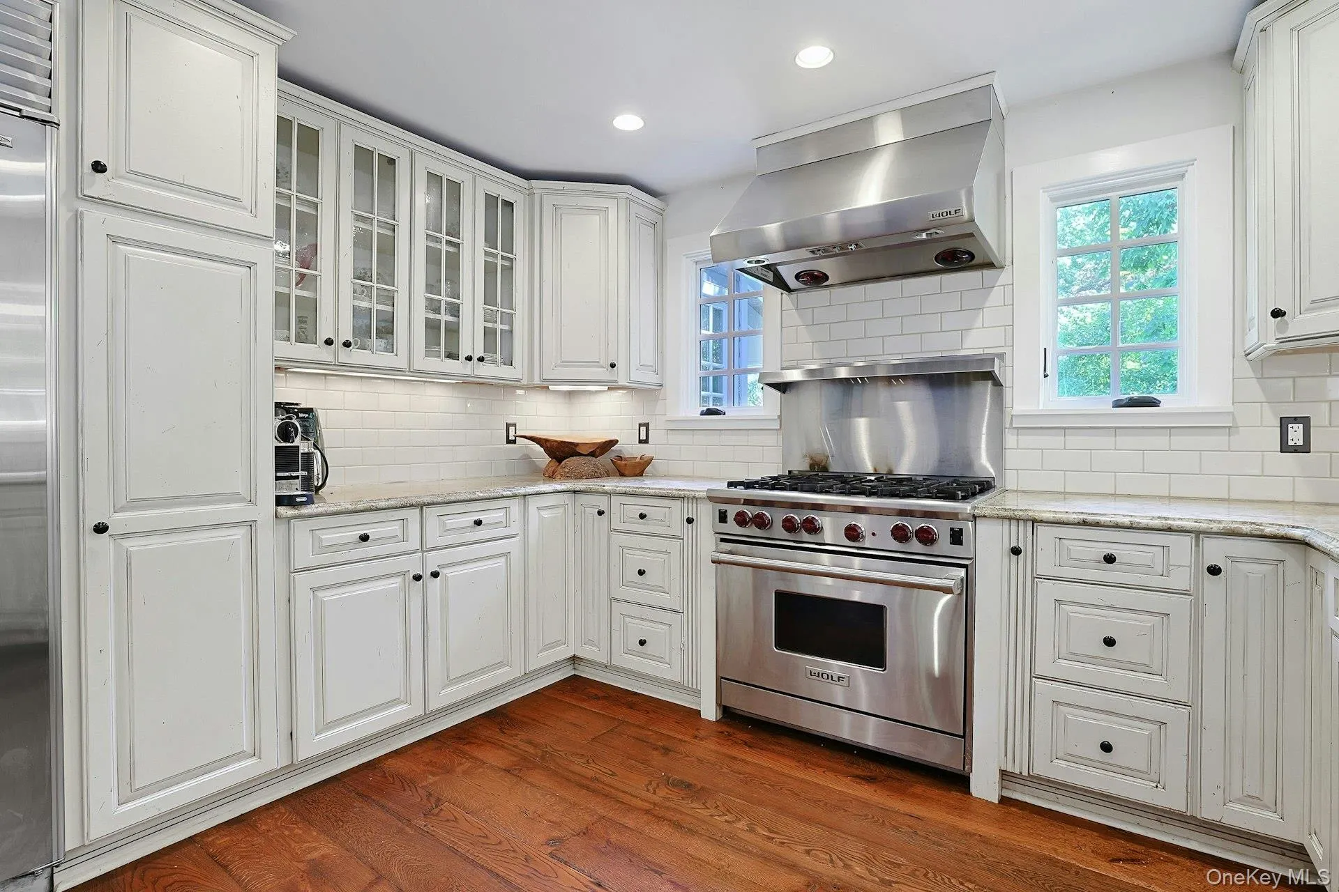 A chef’s kitchen with a Wolf stove, generous workspace, and beautiful backyard views, designed to make cooking, entertaining, and everyday moments feel effortless. A chef’s kitchen with a Wolf stove, generous workspace, and beautiful backyard views, designed to make cooking, entertaining, and everyday moments feel effortless.