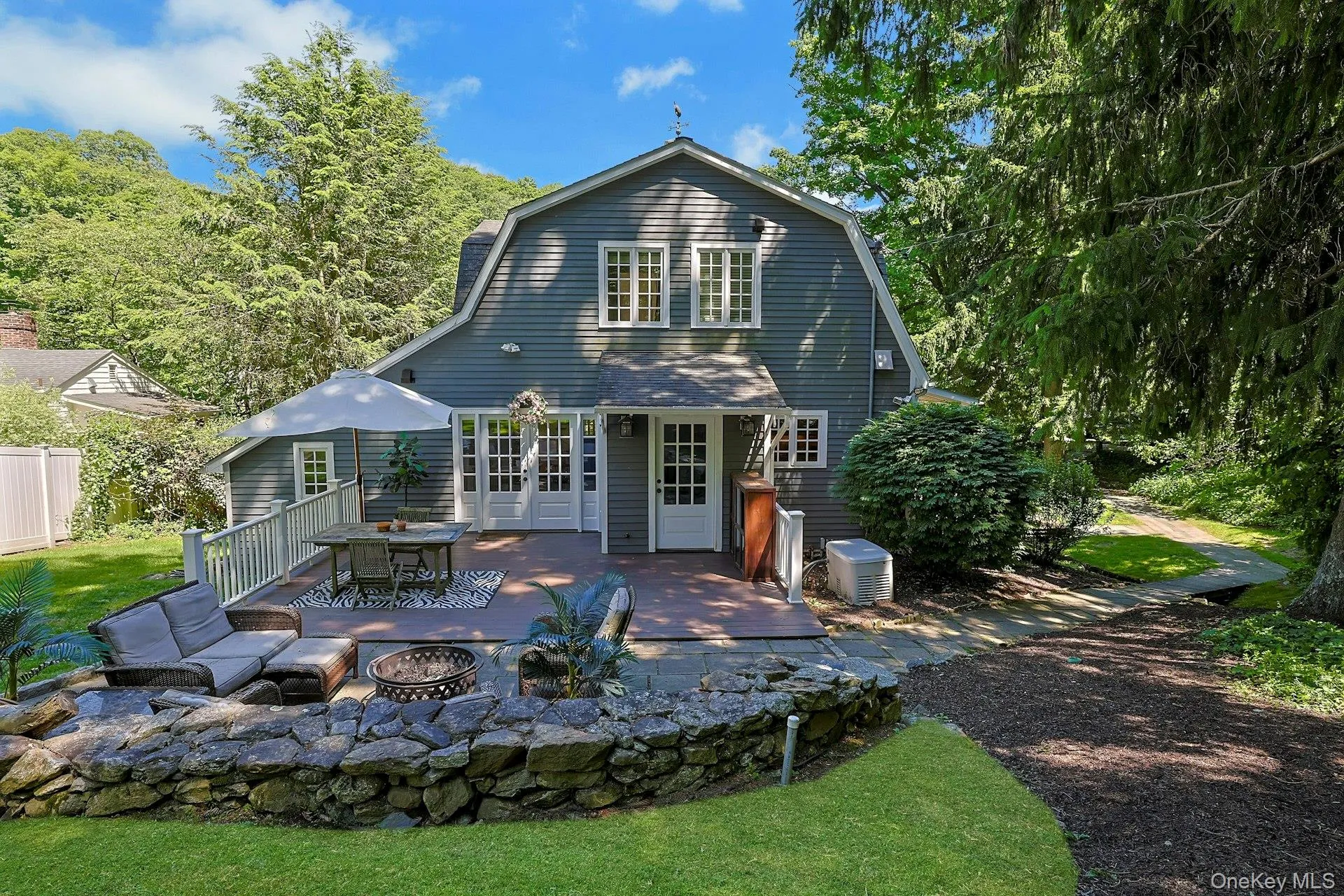 The spacious stone patio and charming walkway create a beautiful outdoor extension of the home. The spacious stone patio and charming walkway create a beautiful outdoor extension of the home.