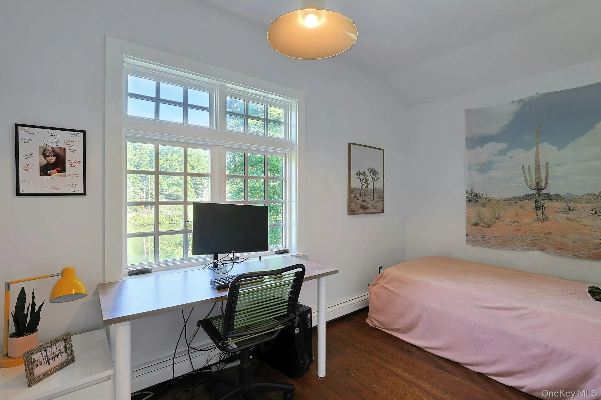 A comfortable third bedroom with a beautiful view of the pond offers a peaceful and inviting space, filled with the natural charm of the property’s waterfront setting. A comfortable third bedroom with a beautiful view of the pond offers a peaceful and inviting space, filled with the natural charm of the property’s waterfront setting.