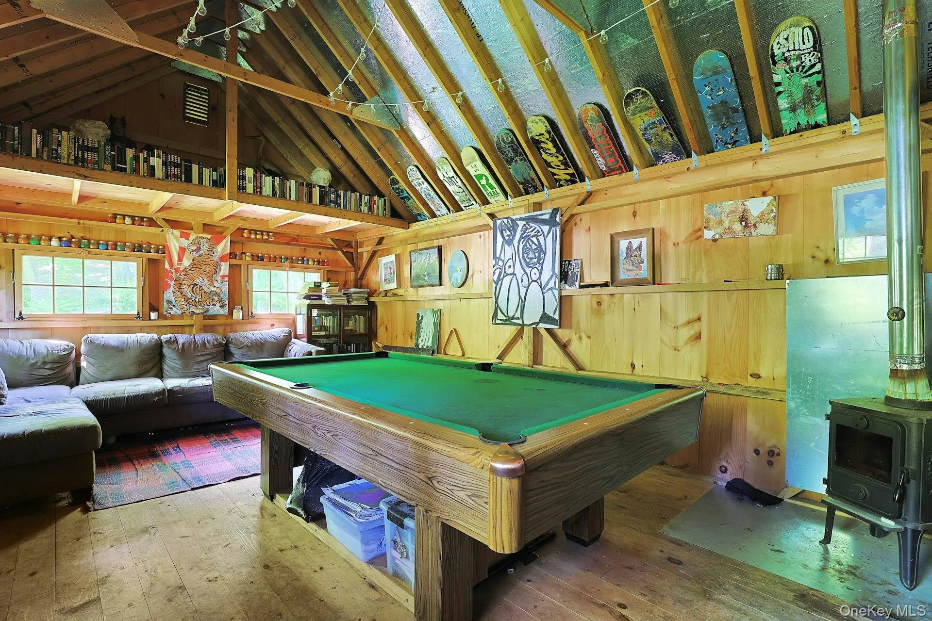 The barn is currently used as a spacious recreation room with a pool table, perfect for game nights and hanging out The barn is currently used as a spacious recreation room with a pool table, perfect for game nights and hanging out