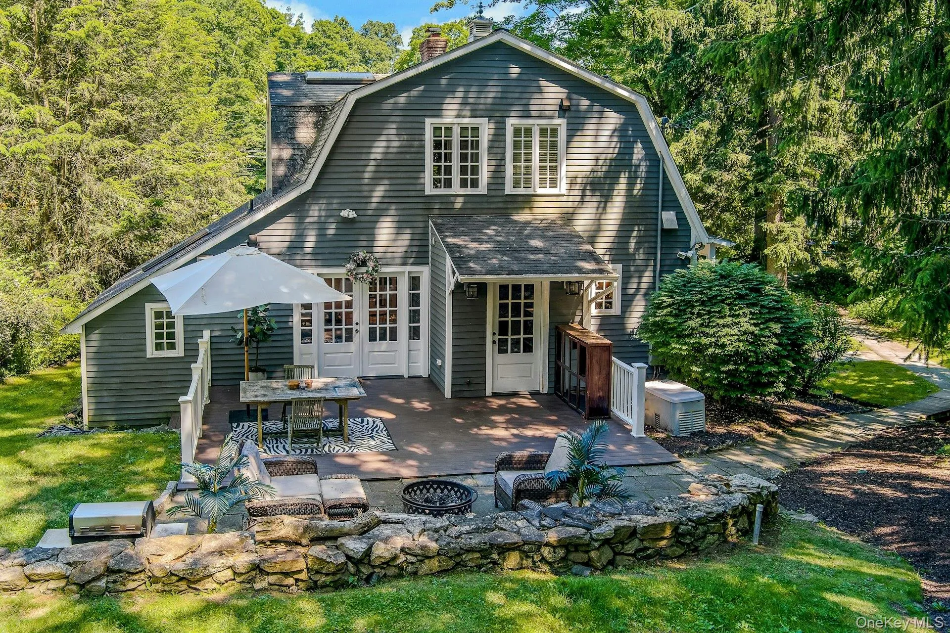 A beautiful stone patio creates the perfect outdoor setting for relaxing, dining, and entertaining around the fire pit, surrounded by the natural beauty of the property. A beautiful stone patio creates the perfect outdoor setting for relaxing, dining, and entertaining around the fire pit, surrounded by the natural beauty of the property.