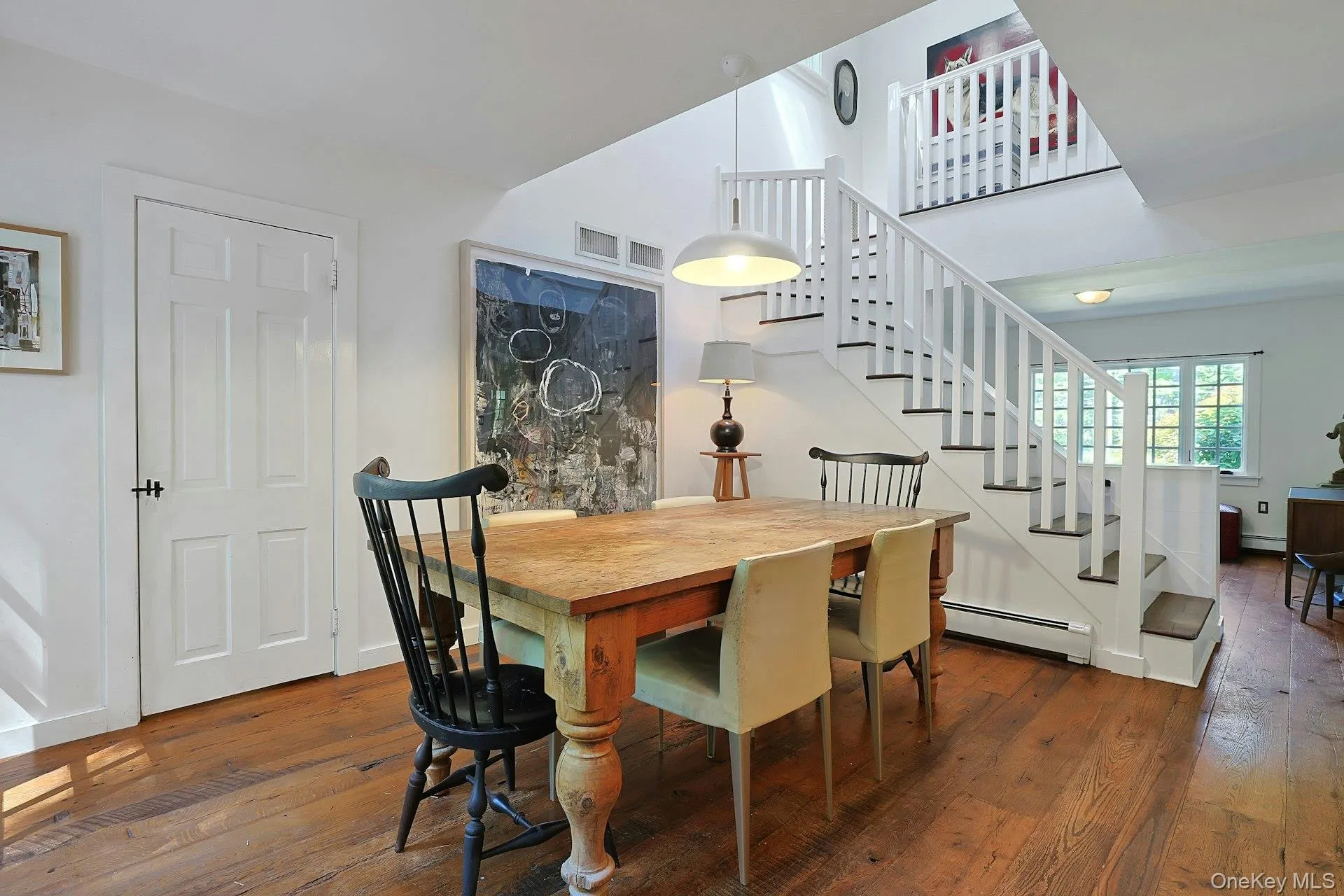 The dining area flows naturally toward the staircase, creating a bright and open connection between the home’s main living spaces and the second floor. The dining area flows naturally toward the staircase, creating a bright and open connection between the home’s main living spaces and the second floor.
