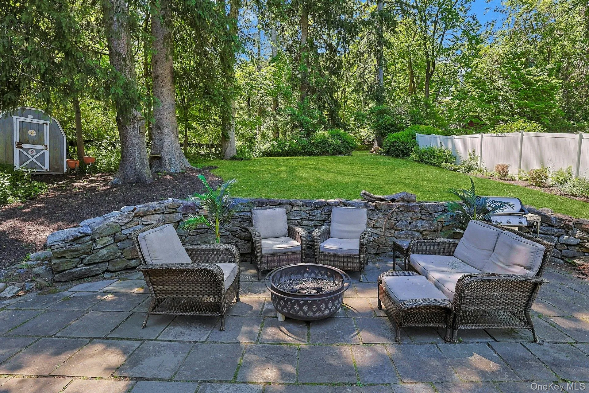 Surrounded by greenery and natural beauty, the backyard offers a quiet escape for outdoor entertaining. Surrounded by greenery and natural beauty, the backyard offers a quiet escape for outdoor entertaining.