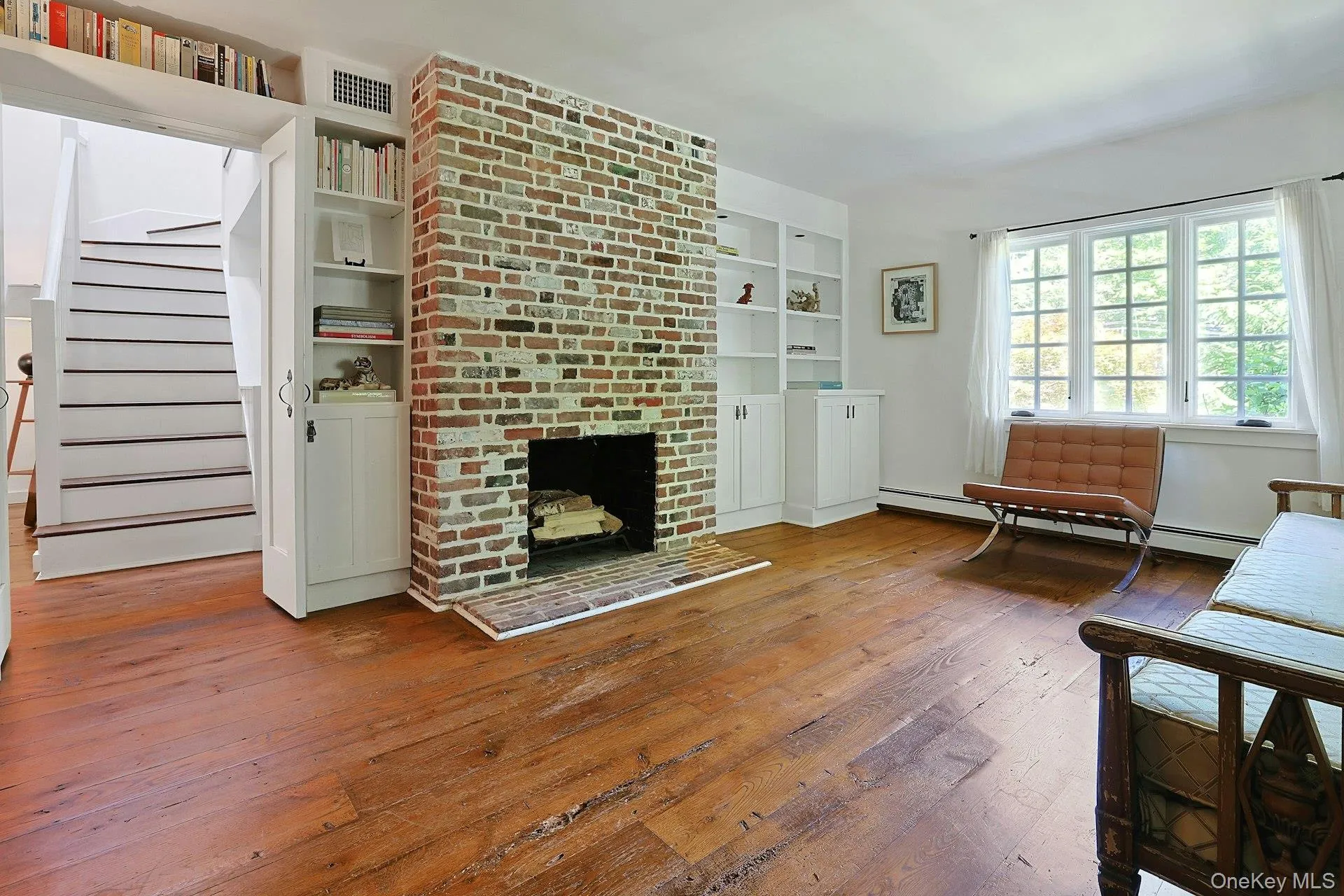 A warm and inviting living room centered around a beautiful brick fireplace, creating the perfect setting for cozy evenings, quiet mornings, and effortless gatherings. A warm and inviting living room centered around a beautiful brick fireplace, creating the perfect setting for cozy evenings, quiet mornings, and effortless gatherings.