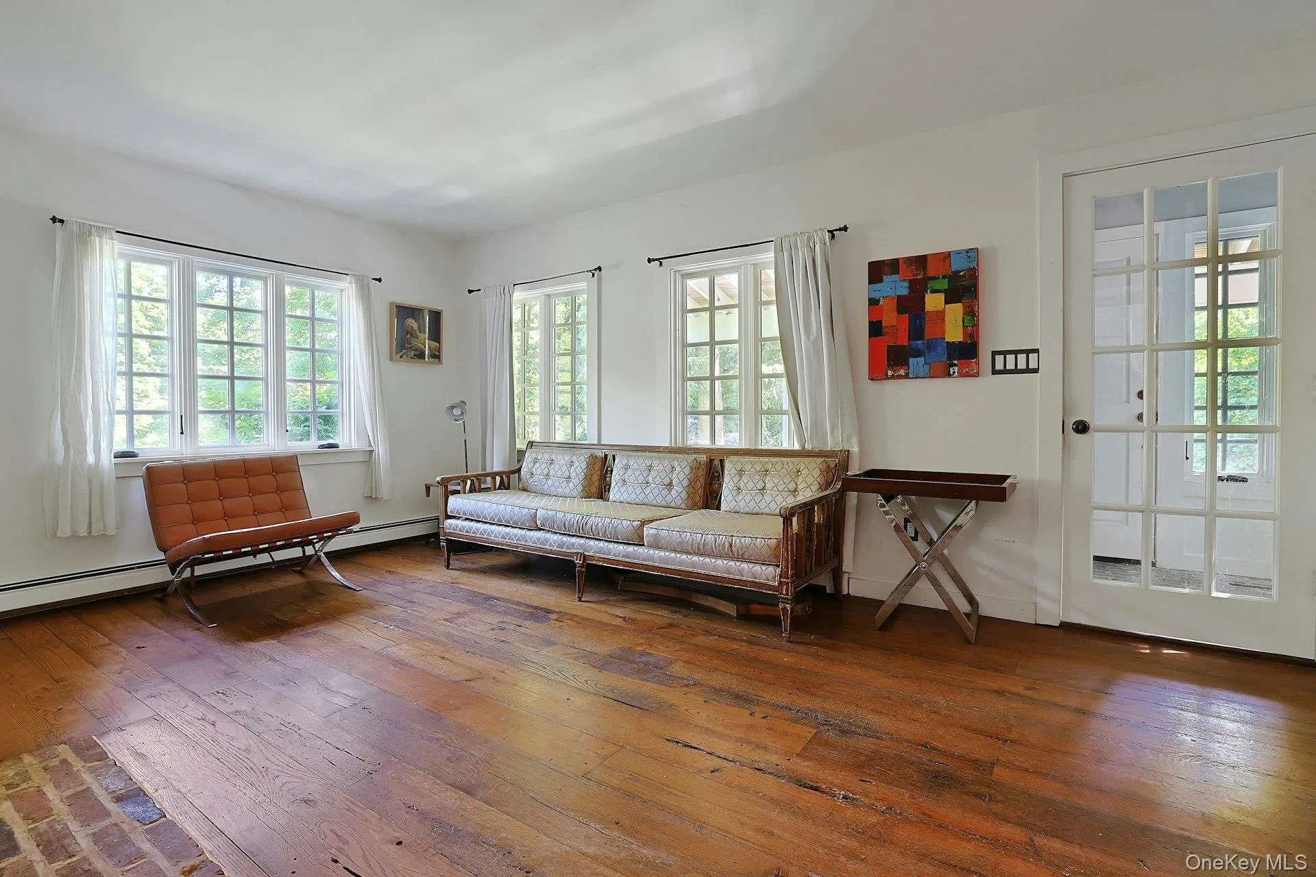Beautifully filled with natural light, spacious living room with French doors leading outside Beautifully filled with natural light, spacious living room with French doors leading outside