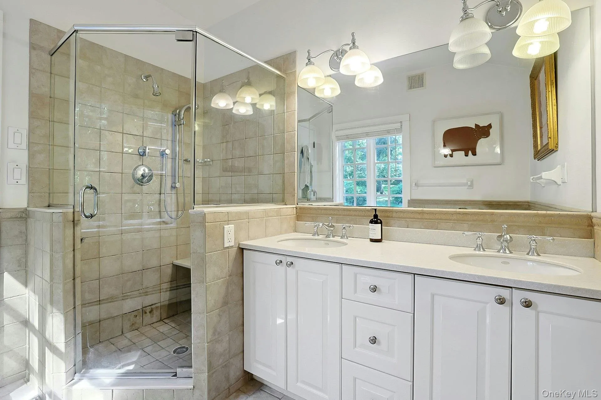 A beautiful, light-filled bathroom features a walk in shower, large vanity and and a lovely view outside, creating a bright and refreshing spa space for everyday ablutions. A beautiful, light-filled bathroom features a walk in shower, large vanity and and a lovely view outside, creating a bright and refreshing spa space for everyday ablutions.