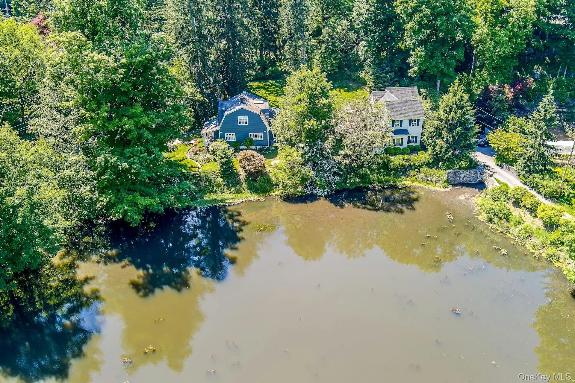 An aerial view beautifully captures the pond and the surrounding landscape, showcasing the peaceful setting and natural beauty that make this property so special. An aerial view beautifully captures the pond and the surrounding landscape, showcasing the peaceful setting and natural beauty that make this property so special.