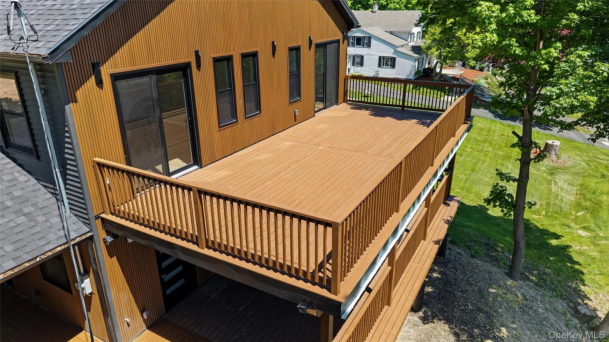 Multi-level exterior decks with wood-finish decking and railings Multi-level exterior decks with wood-finish decking and railings