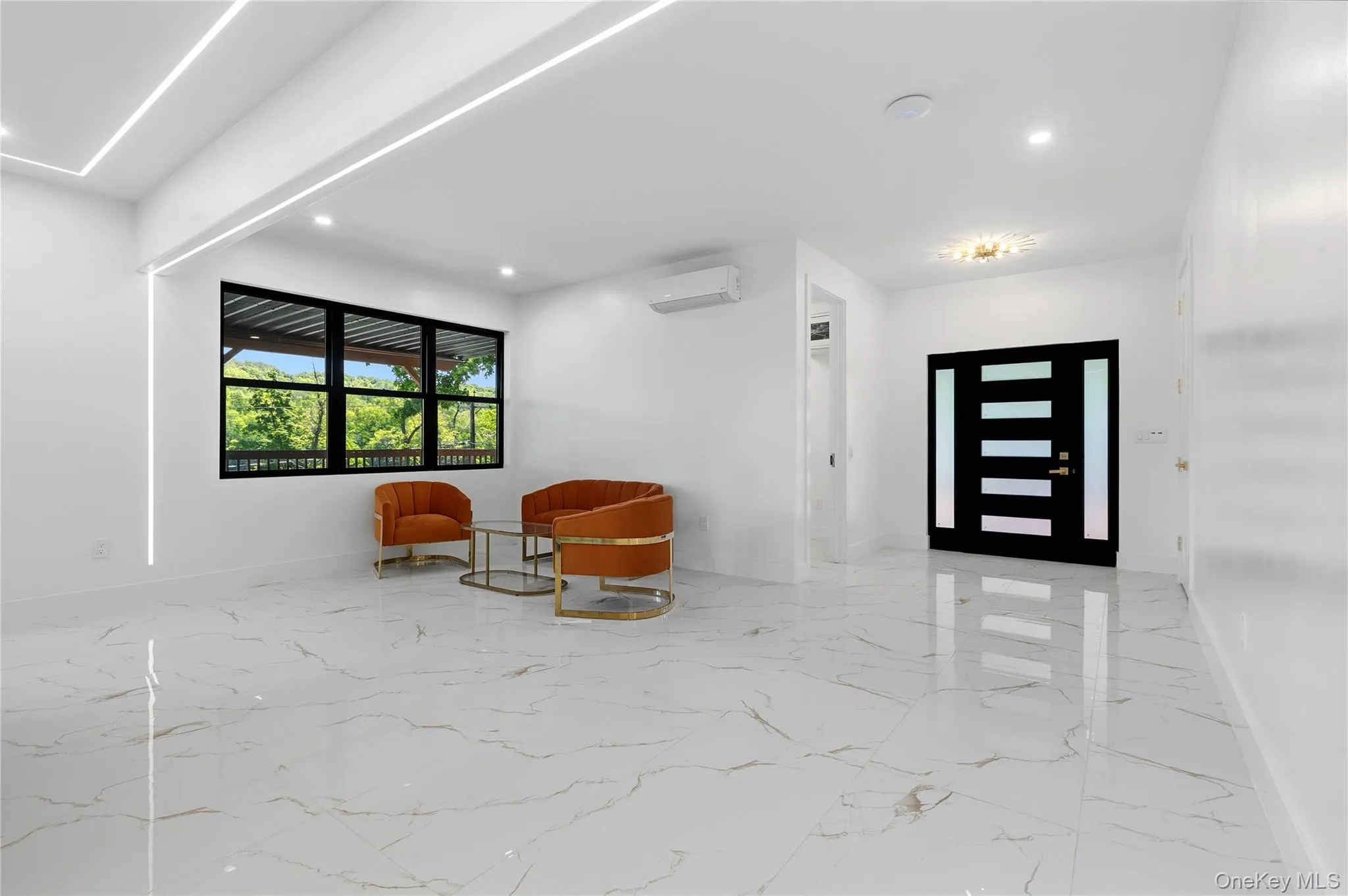 Spacious room with polished tile flooring, recessed lighting, and integrated linear lighting Spacious room with polished tile flooring, recessed lighting, and integrated linear lighting