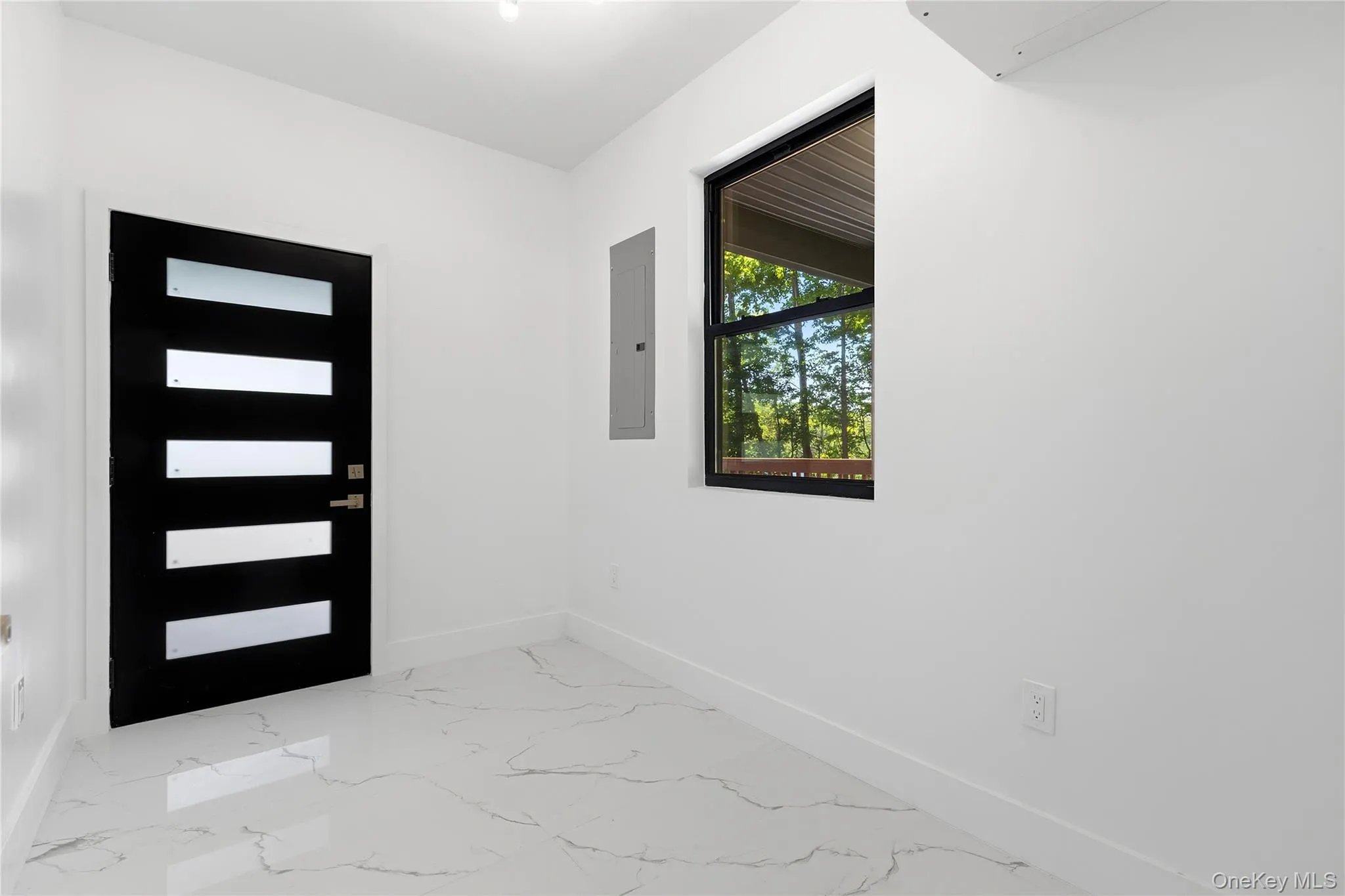 Modern entry featuring a black door with frosted glass panels, white walls, and marbling-effect tile flooring Modern entry featuring a black door with frosted glass panels, white walls, and marbling-effect tile flooring