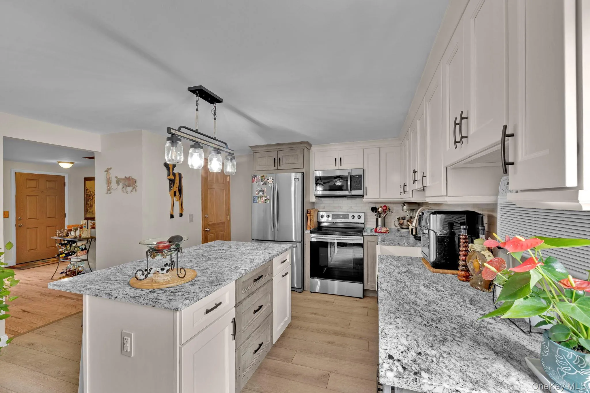 Kitchen with eat-in dining area and sliders to back deck Kitchen with eat-in dining area and sliders to back deck