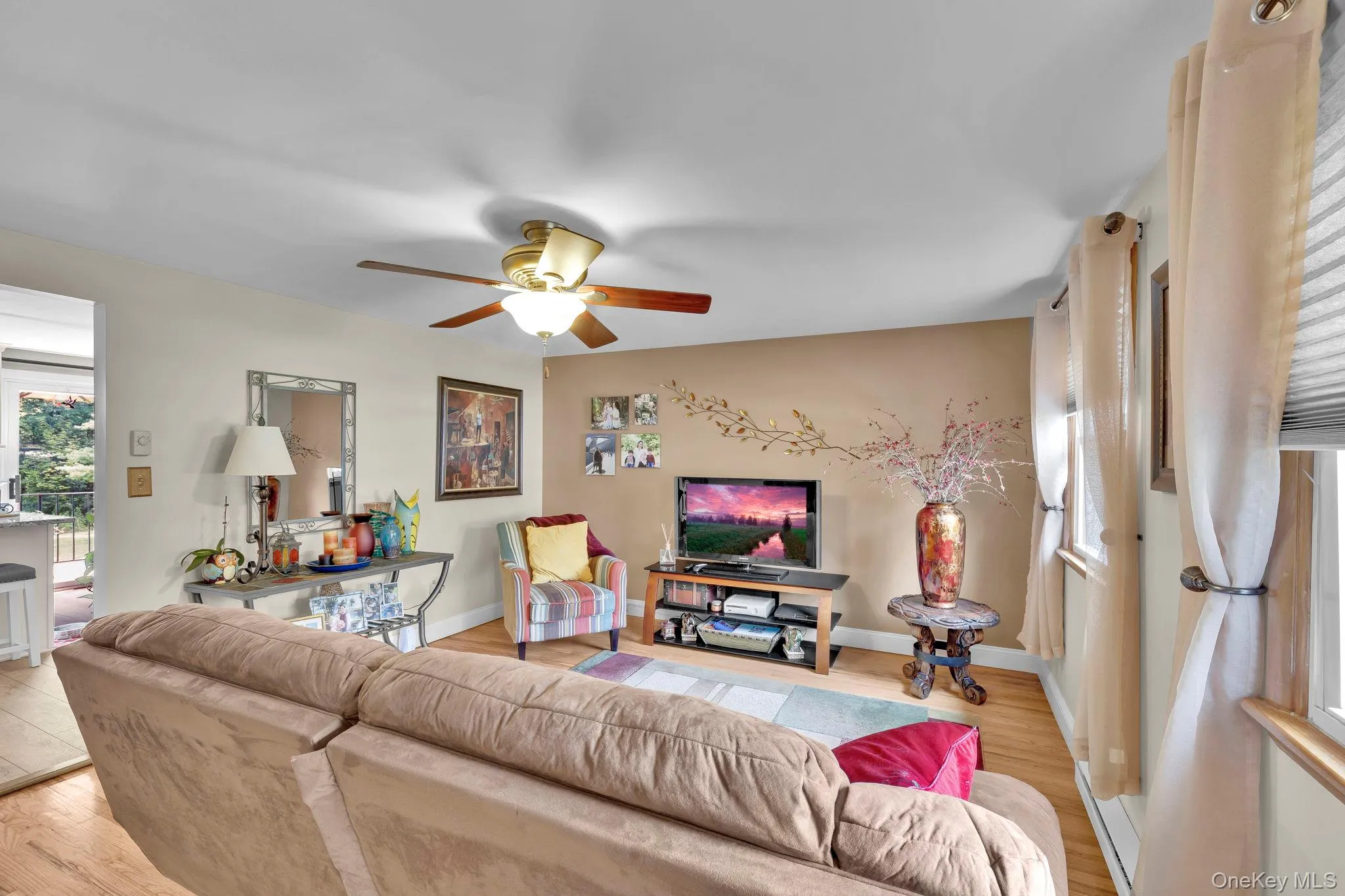 Beautiful hardwood floors + ceiling fan with new windows in the Living Room Beautiful hardwood floors + ceiling fan with new windows in the Living Room