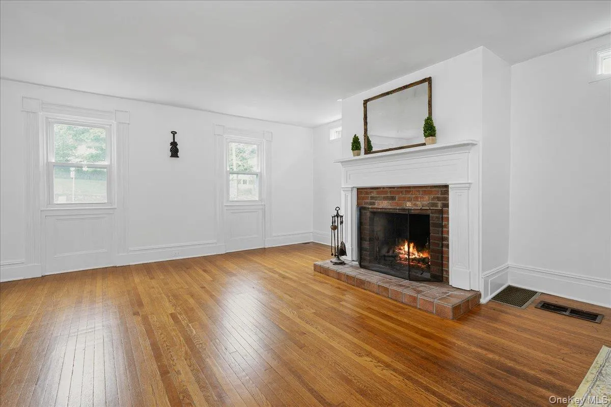 Looking toward front of house. Note all the trim, particularly around the fireplace and front windows. Looking toward front of house. Note all the trim, particularly around the fireplace and front windows.
