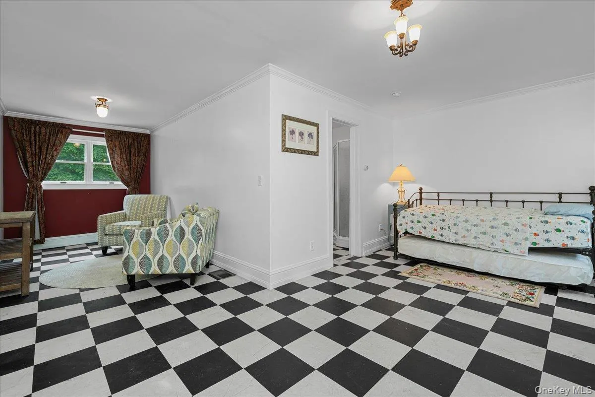 This L-shaped room is presently set up to serve as bedroom and living room. This L-shaped room is presently set up to serve as bedroom and living room.