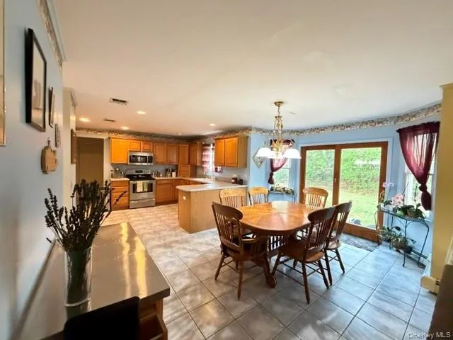 Open-concept kitchen and dining area featuring ceramic tile flooring Open-concept kitchen and dining area featuring ceramic tile flooring