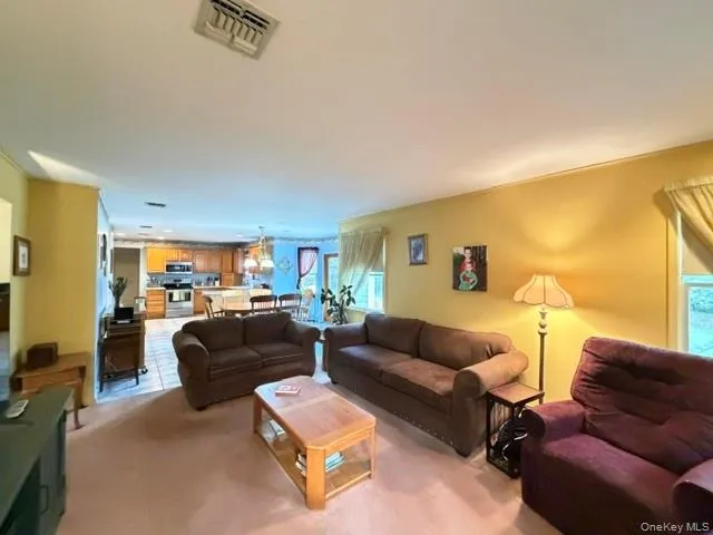 Open concept living area with broad room dimensions and a clear sightline to the kitchen Open concept living area with broad room dimensions and a clear sightline to the kitchen