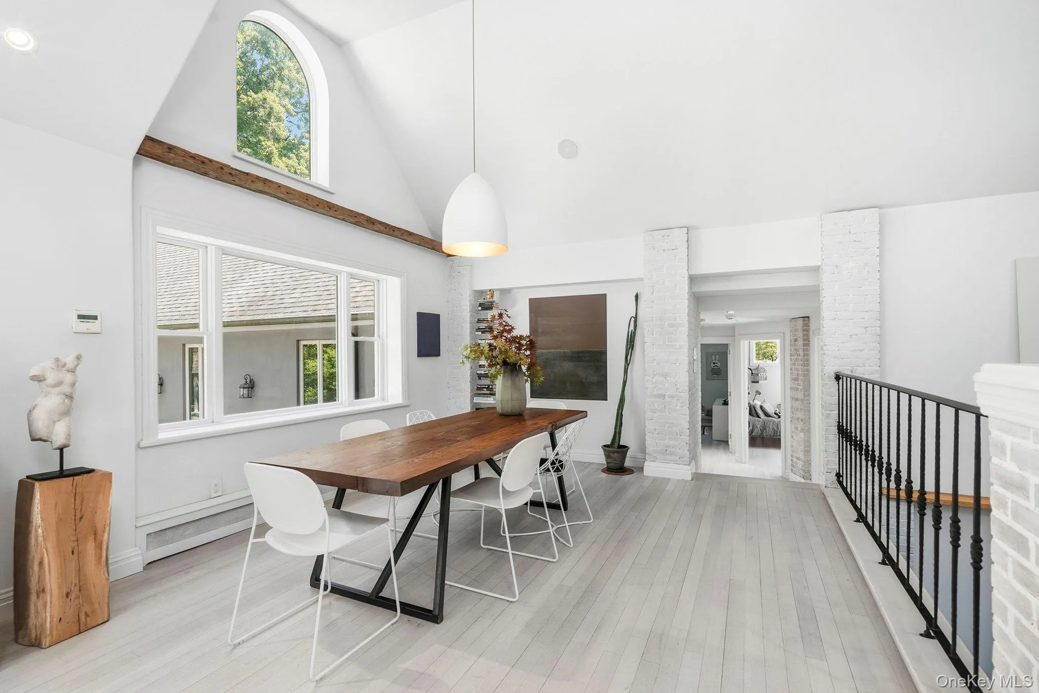 White washed brick, light cherry floors with vaulted ceiling the hand-hewn beam and clerestory window for soft, ambient natural light. White washed brick, light cherry floors with vaulted ceiling the hand-hewn beam and clerestory window for soft, ambient natural light.