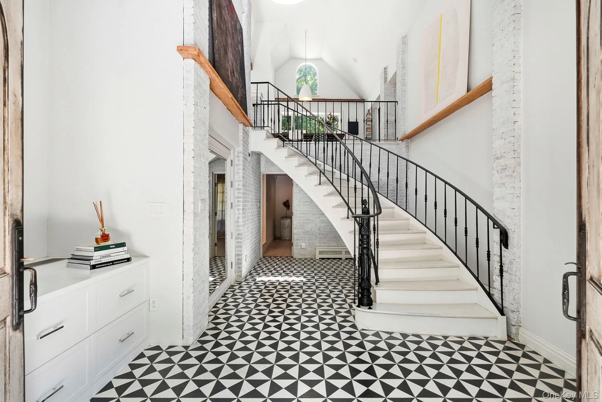 Entryway grand staircase, an impressive entrance with original hand-hewn beams. There is a large cedar closet Entryway grand staircase, an impressive entrance with original hand-hewn beams. There is a large cedar closet