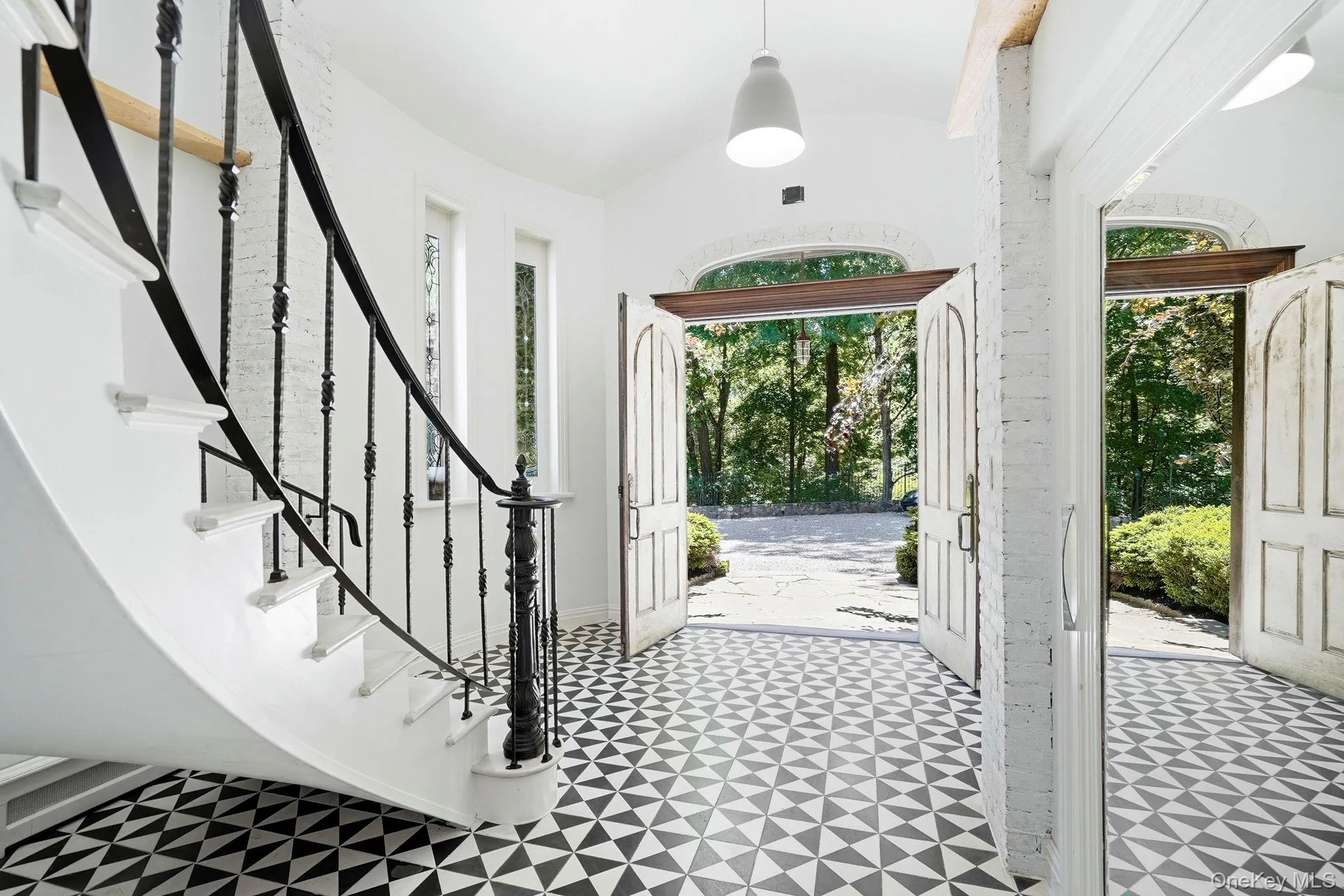 Tall, narrow vertical windows flank the double-door entry, crowned by a graceful lunette window above, Tall, narrow vertical windows flank the double-door entry, crowned by a graceful lunette window above,