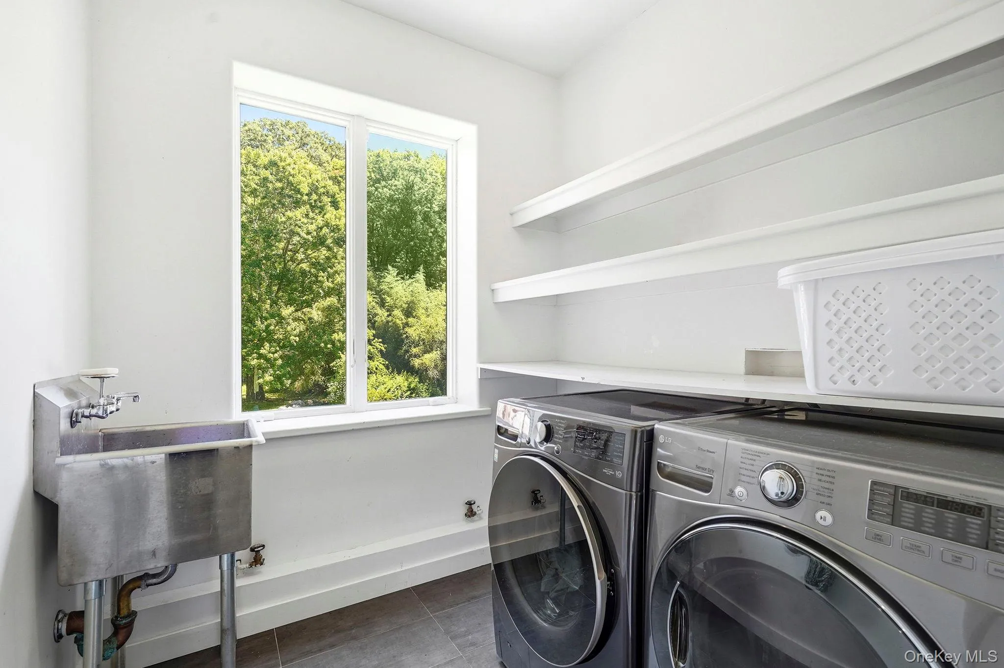 North wing garden level laundry. LG washer and dryer. North wing garden level laundry. LG washer and dryer.
