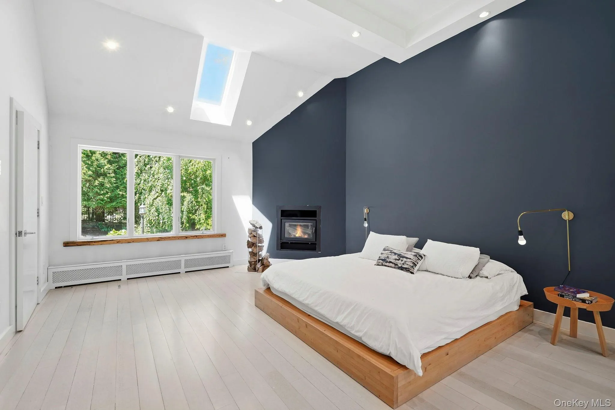 The home's vaulted ceiling adds architectural drama, while the lightened cherry flooring extends effortlessly throughout, creating a harmonious flow. The home's vaulted ceiling adds architectural drama, while the lightened cherry flooring extends effortlessly throughout, creating a harmonious flow.