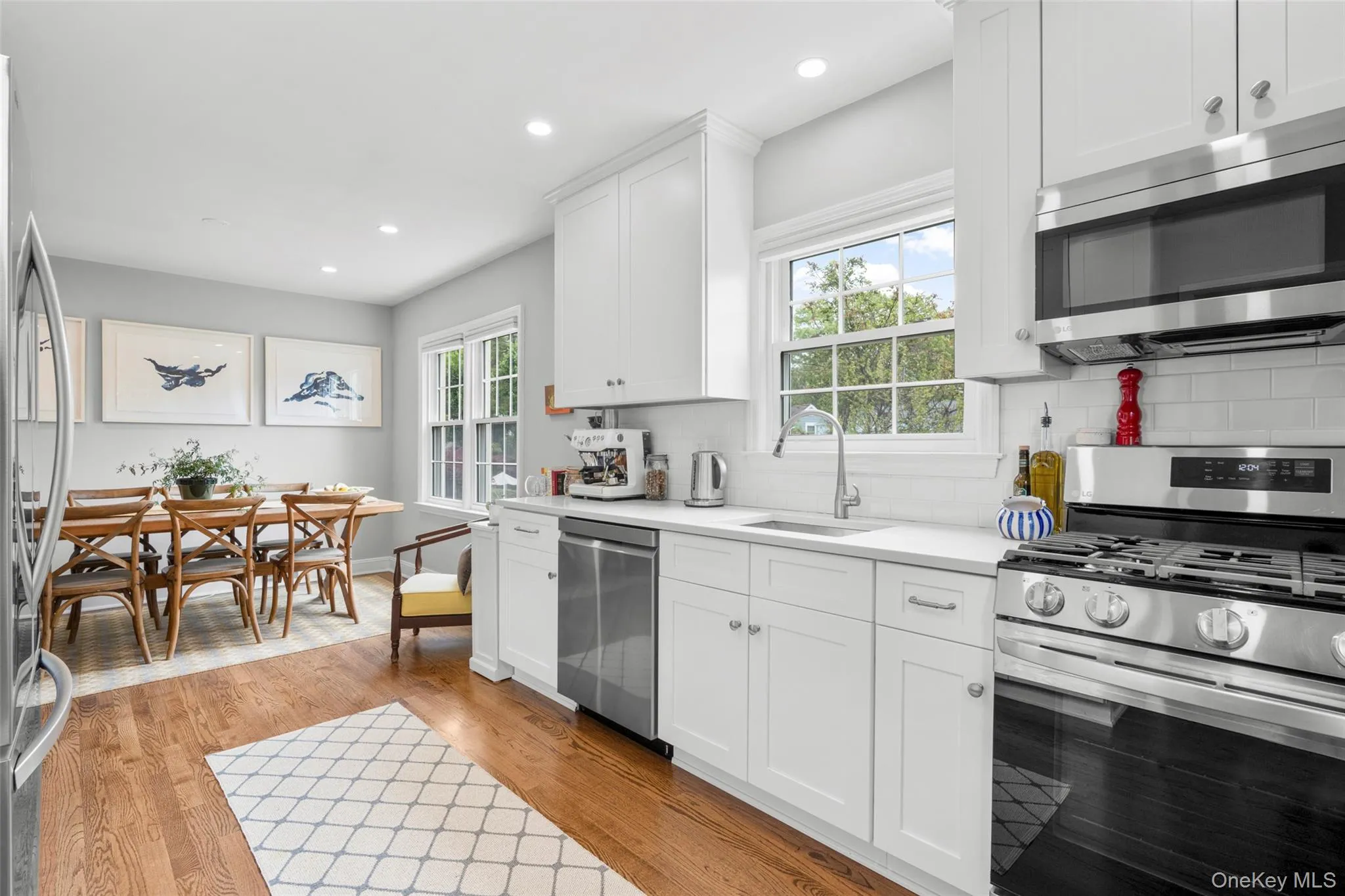 Quartz counters, subway tile backsplash, stainless steel appliances including a 5 burner self cleaning gas range. Quartz counters, subway tile backsplash, stainless steel appliances including a 5 burner self cleaning gas range.