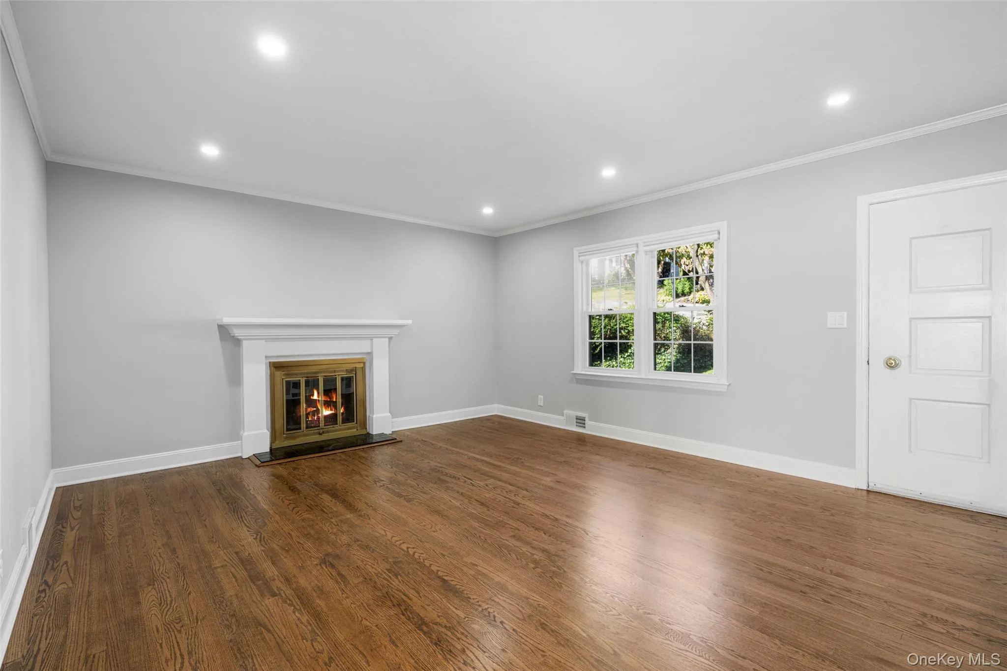 Living room has a wood burning fireplace and an entry closet (not shown in photo). Living room has a wood burning fireplace and an entry closet (not shown in photo).