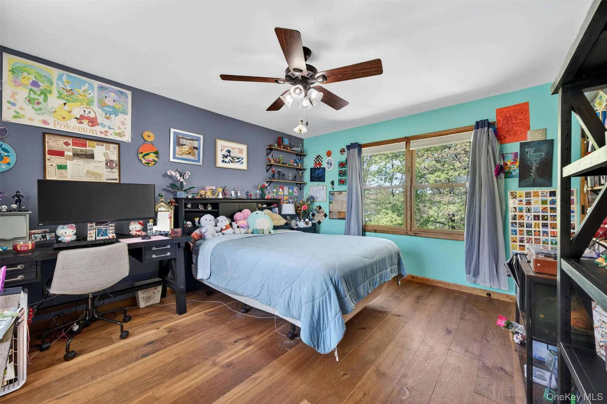 One of the home's secondary bedrooms, offering a bright and inviting atmosphere with two windows and the added luxury of a private walk-in closet. One of the home's secondary bedrooms, offering a bright and inviting atmosphere with two windows and the added luxury of a private walk-in closet.