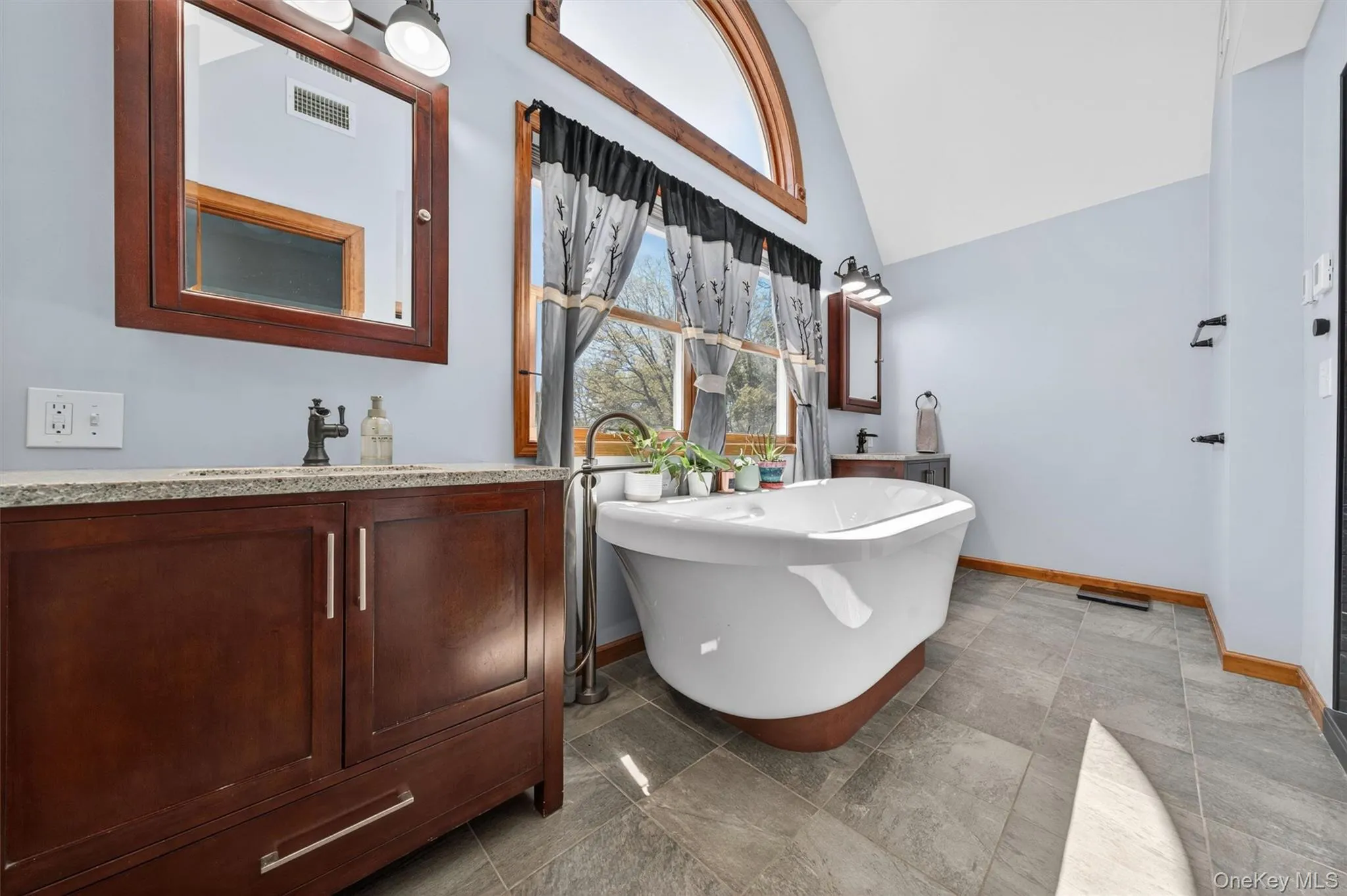 Renovated in 2025, the spa-style bathroom offers dual vanities and a luxurious soaking air tub. Renovated in 2025, the spa-style bathroom offers dual vanities and a luxurious soaking air tub.