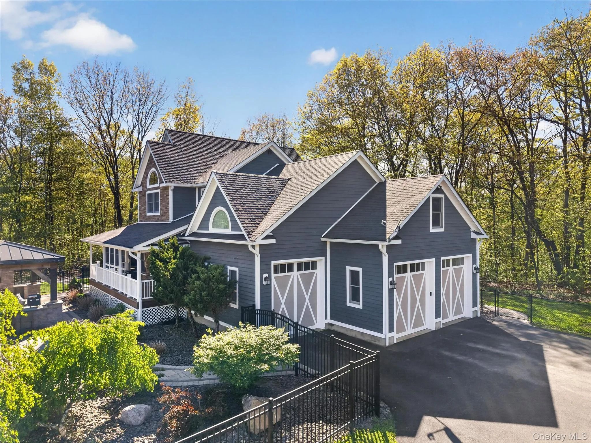 The sweeping driveway leads to an impressive three-bay garage, fully equipped with heating and air conditioning for year-round climate-controlled storage or workshop use. The sweeping driveway leads to an impressive three-bay garage, fully equipped with heating and air conditioning for year-round climate-controlled storage or workshop use.