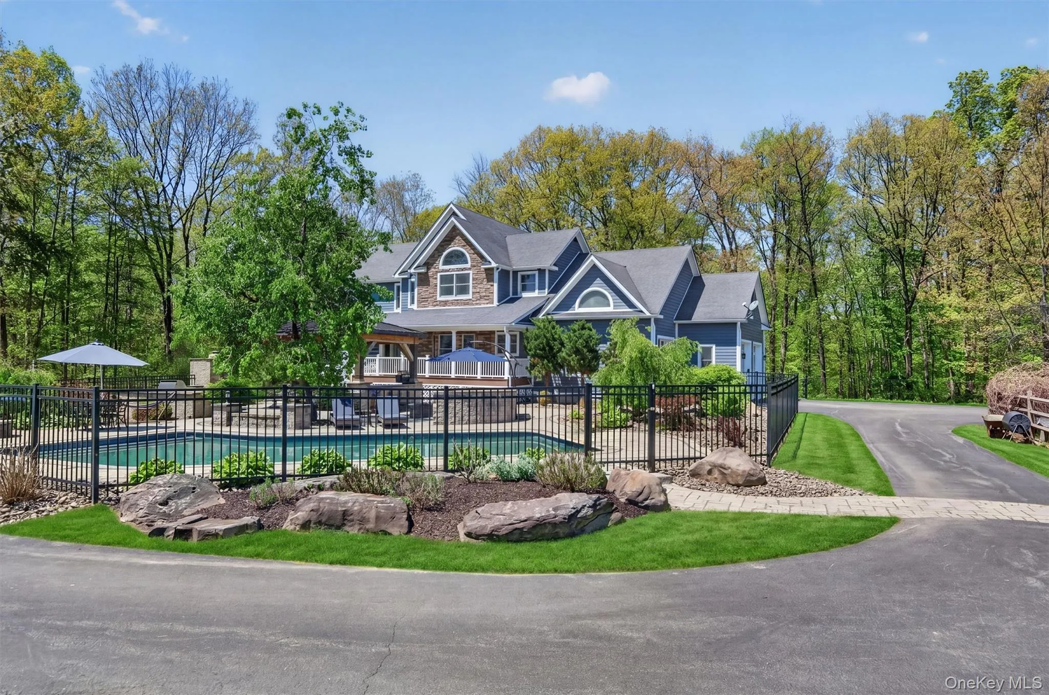 The sprawling, sun-drenched patio offers a vast footprint for poolside lounging and outdoor dining, perfect for hosting summer gatherings on a grand scale. The sprawling, sun-drenched patio offers a vast footprint for poolside lounging and outdoor dining, perfect for hosting summer gatherings on a grand scale.