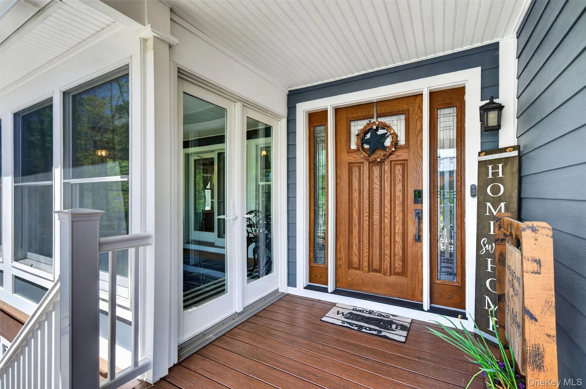 A warm and inviting front entrance welcomes you home, featuring a beautiful wood door and a cozy screened-in porch perfect for morning coffee. A warm and inviting front entrance welcomes you home, featuring a beautiful wood door and a cozy screened-in porch perfect for morning coffee.