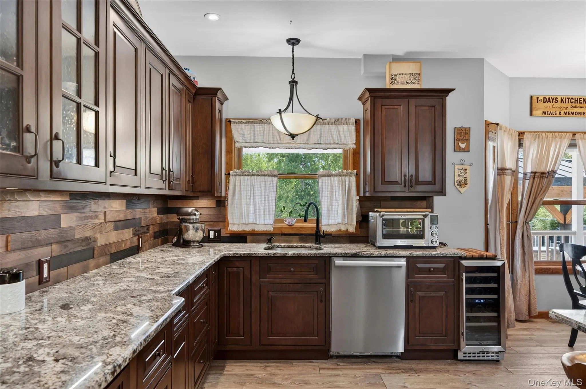 The kitchen showcases sweeping granite countertops, rich custom cabinetry, premium stainless steel appliances, and an abundance of workspace for cooking, baking, and gathering alike. The kitchen showcases sweeping granite countertops, rich custom cabinetry, premium stainless steel appliances, and an abundance of workspace for cooking, baking, and gathering alike.