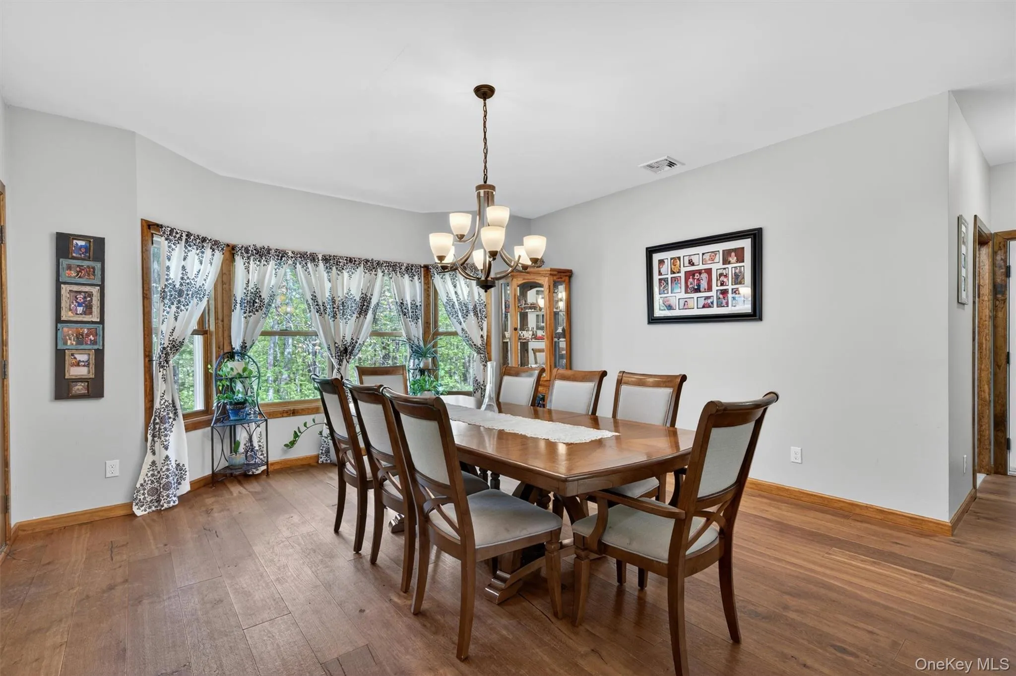 Adjacent to the living room is the formal dining room. Large and inviting, this room is built for large parties and punctuated by a cheerful bay window at one end. Adjacent to the living room is the formal dining room. Large and inviting, this room is built for large parties and punctuated by a cheerful bay window at one end.