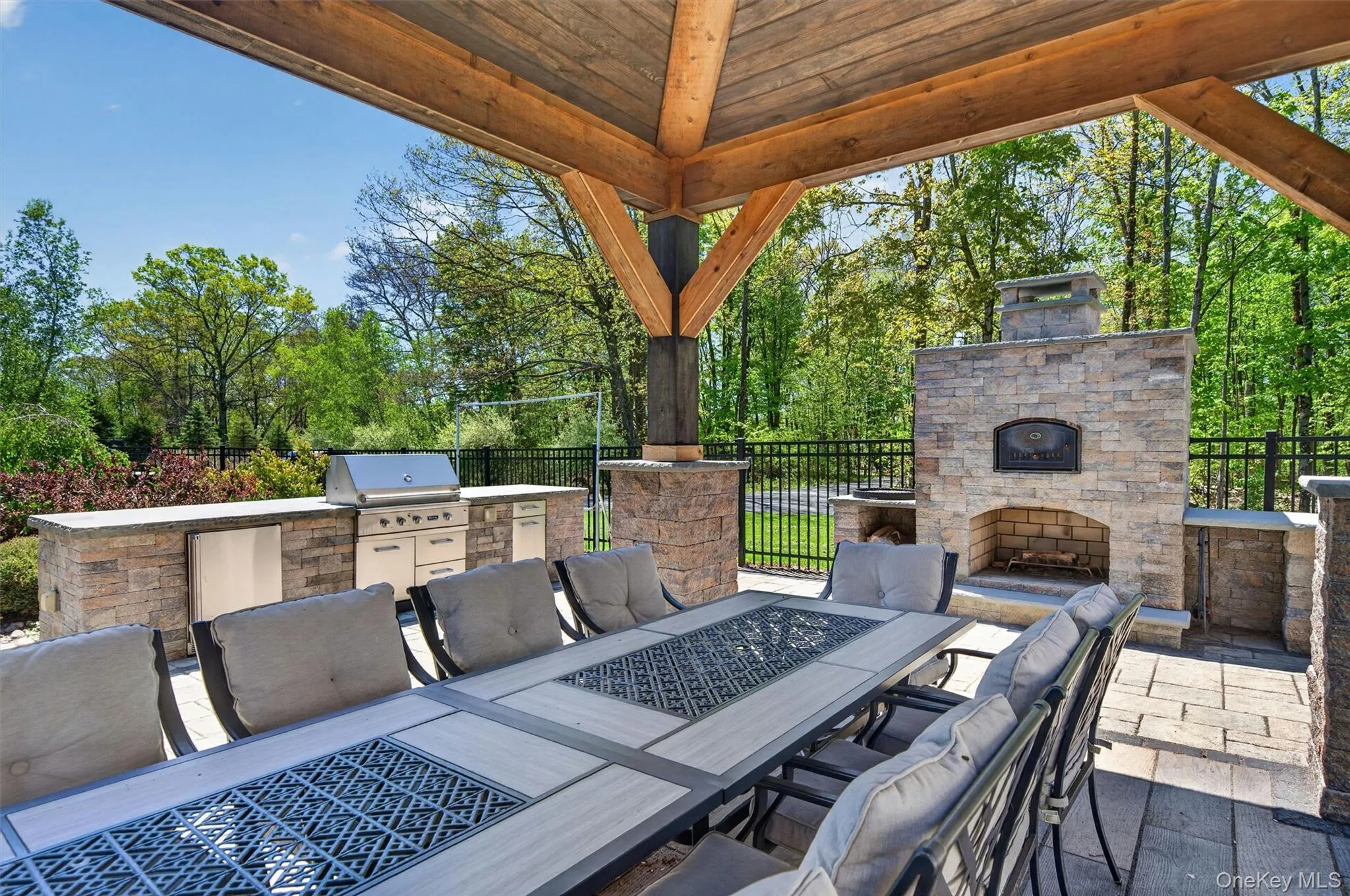 Elevate your outdoor dining experience under the shade of the pergola, complete with a professional-grade kitchen and a wood-fired brick oven for the ultimate pizza night. Elevate your outdoor dining experience under the shade of the pergola, complete with a professional-grade kitchen and a wood-fired brick oven for the ultimate pizza night.