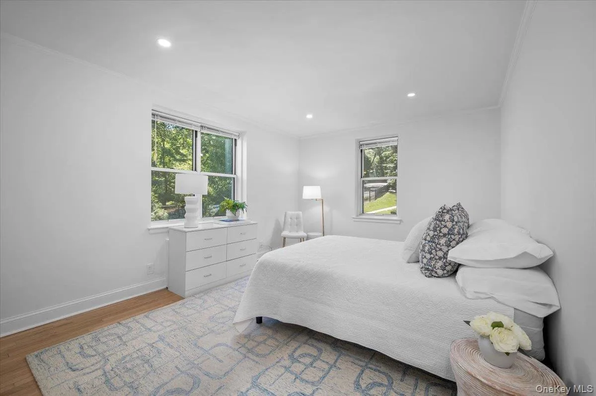 Spacious primary bedroom offers refinished hardwood floors, recessed lighting, multiple windows, and a fresh neutral palette ready for a variety of furnishings. Spacious primary bedroom offers refinished hardwood floors, recessed lighting, multiple windows, and a fresh neutral palette ready for a variety of furnishings.