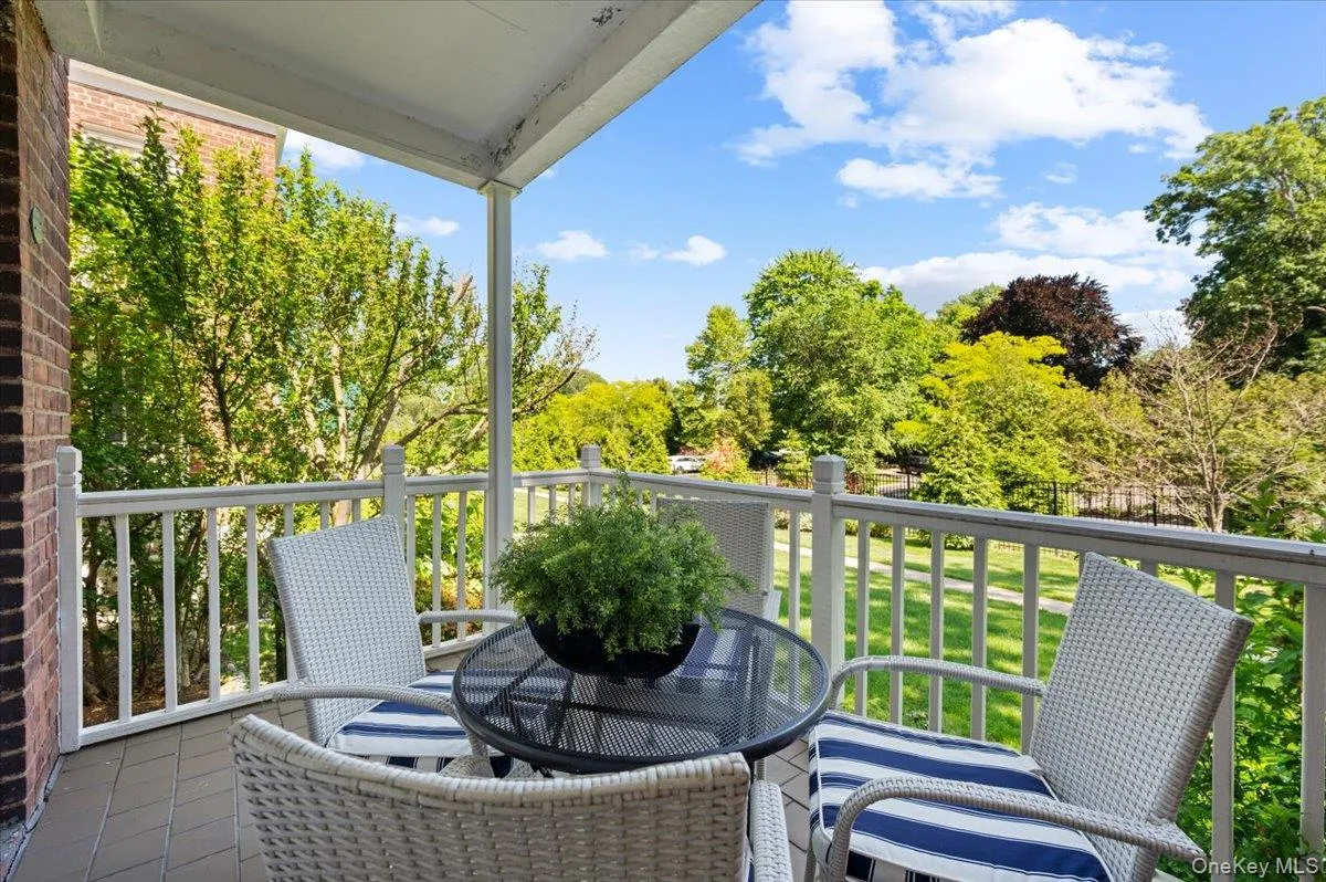 The covered patio offers a comfortable outdoor seating area overlooking the landscaped courtyard and mature trees for year-round enjoyment The covered patio offers a comfortable outdoor seating area overlooking the landscaped courtyard and mature trees for year-round enjoyment