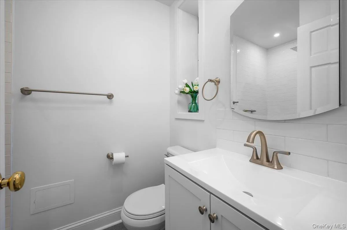 Updated bathroom includes a white vanity, medicine cabinet, subway tile backsplash and oversized walk-in shower. Updated bathroom includes a white vanity, medicine cabinet, subway tile backsplash and oversized walk-in shower.