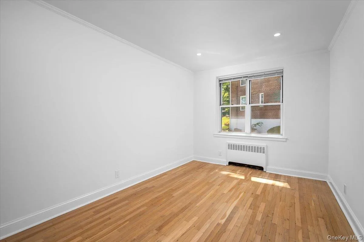 Second Bedroom with hardwood floors, recessed lighting, and a large window Second Bedroom with hardwood floors, recessed lighting, and a large window