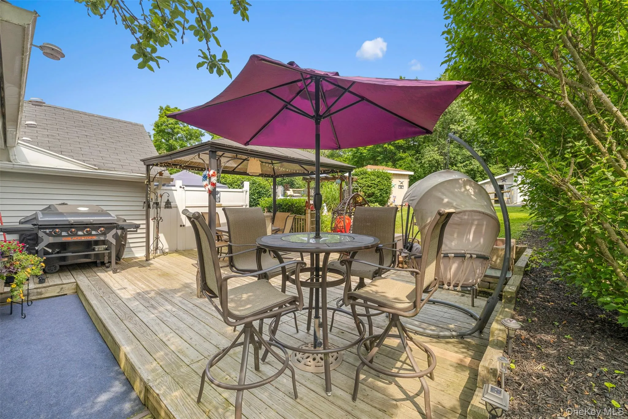 Deck with a gazebo, outdoor dining area, and area for grilling Deck with a gazebo, outdoor dining area, and area for grilling