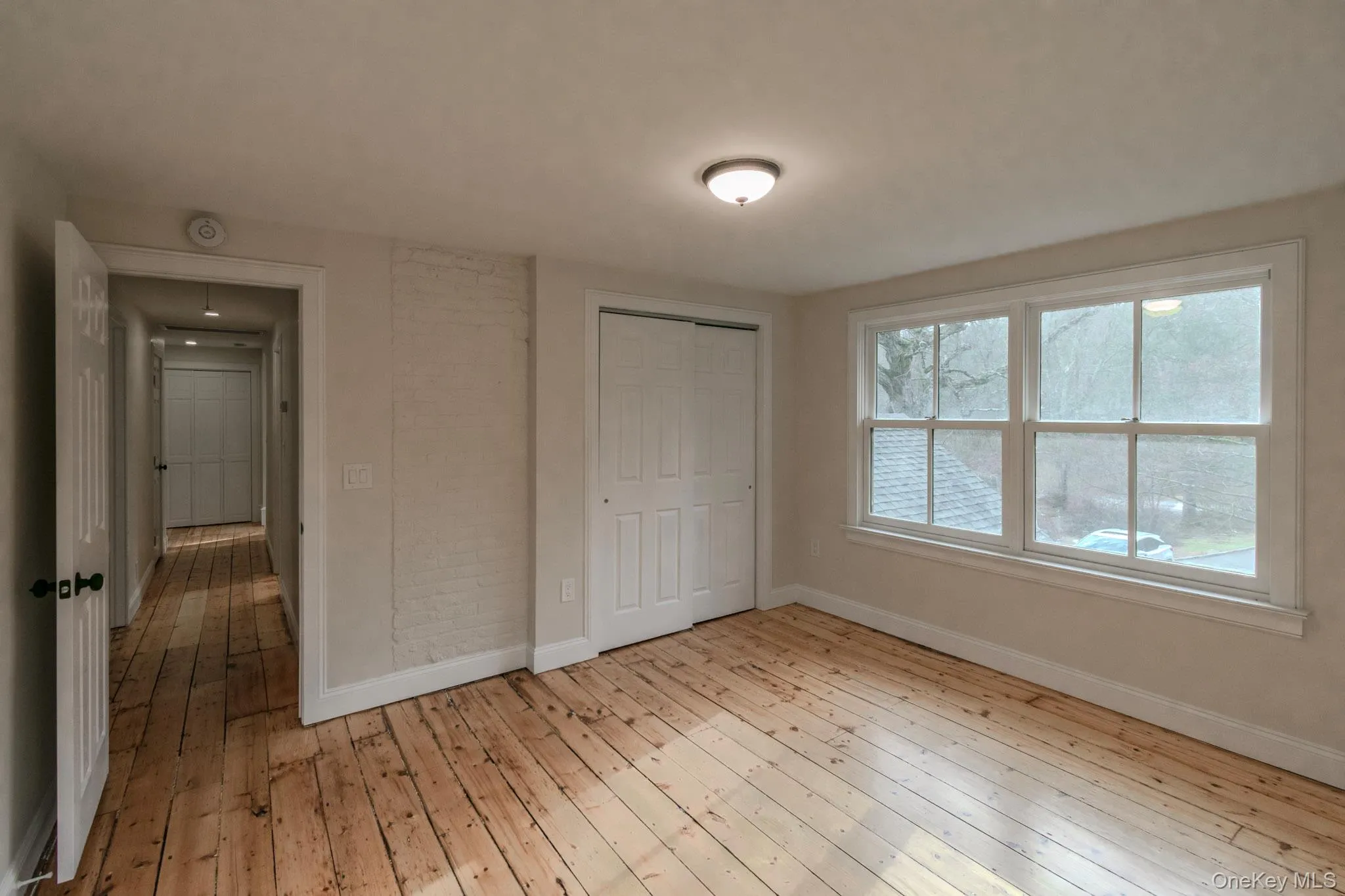 Unfurnished bedroom featuring light hardwood / wood-style floors and a closet Unfurnished bedroom featuring light hardwood / wood-style floors and a closet
