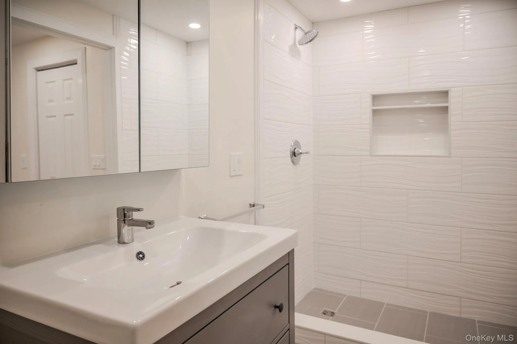 Bathroom with a tile shower and vanity Bathroom with a tile shower and vanity