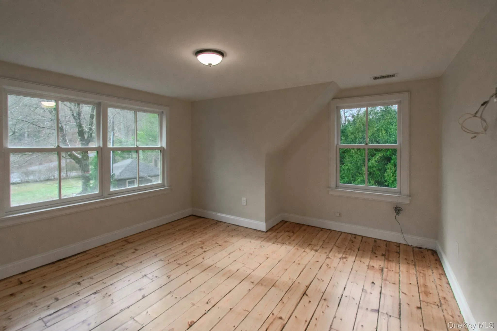 Bonus room with light hardwood / wood-style flooring Bonus room with light hardwood / wood-style flooring
