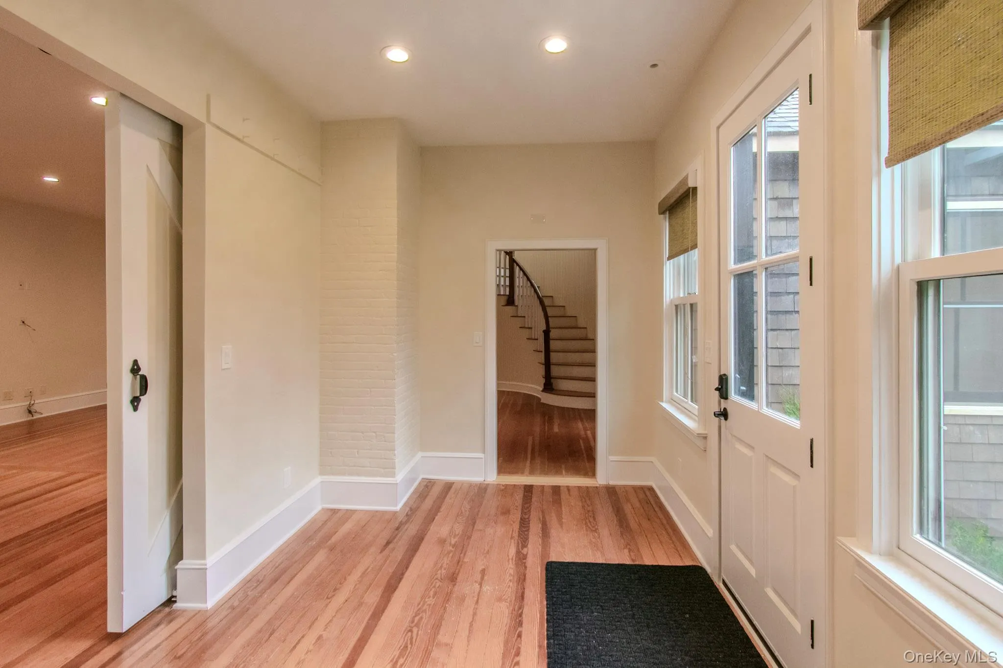 Doorway with light hardwood / wood-style floors and a healthy amount of sunlight Doorway with light hardwood / wood-style floors and a healthy amount of sunlight