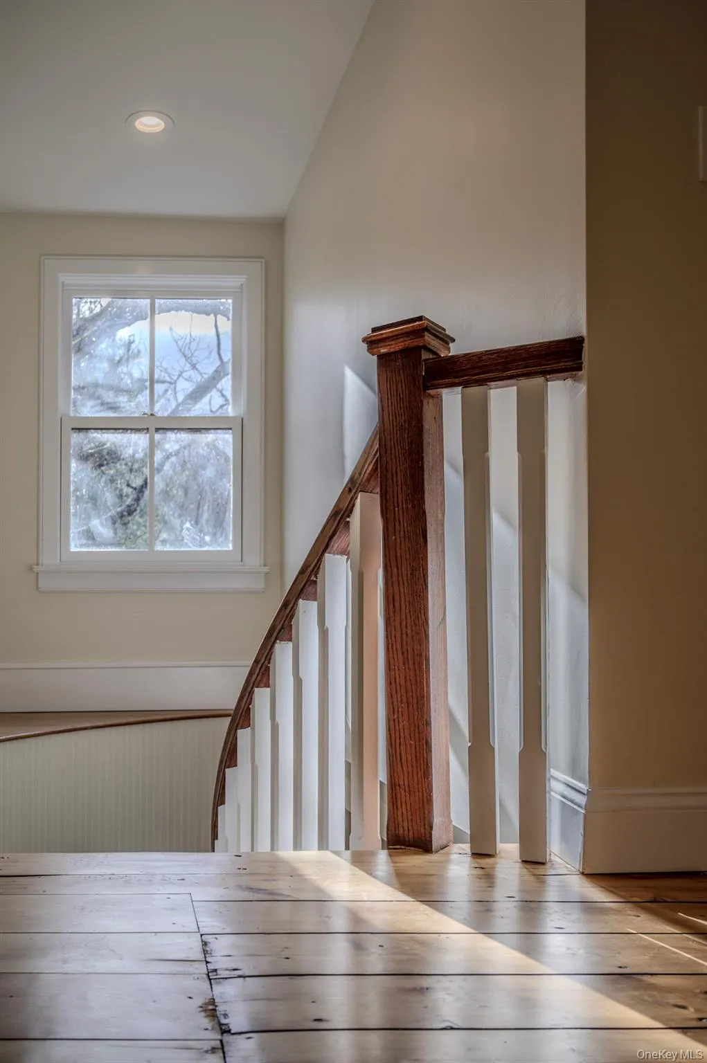 Stairs featuring hardwood / wood-style floors and vaulted ceiling Stairs featuring hardwood / wood-style floors and vaulted ceiling
