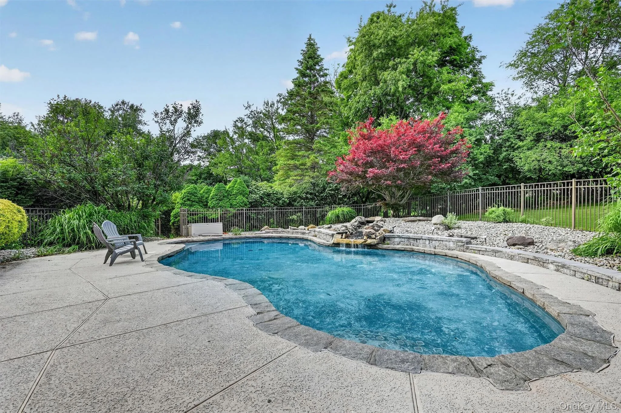 Beautiful unground pool with waterfall feature Beautiful unground pool with waterfall feature