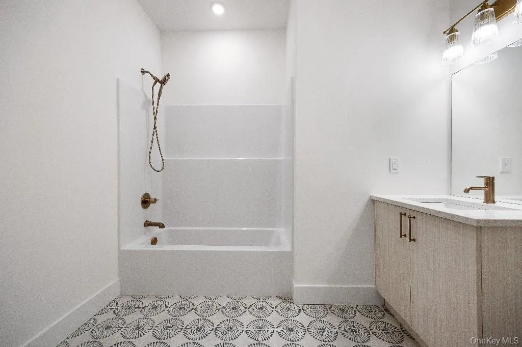 Bathroom featuring vanity and tub / shower combination Bathroom featuring vanity and tub / shower combination
