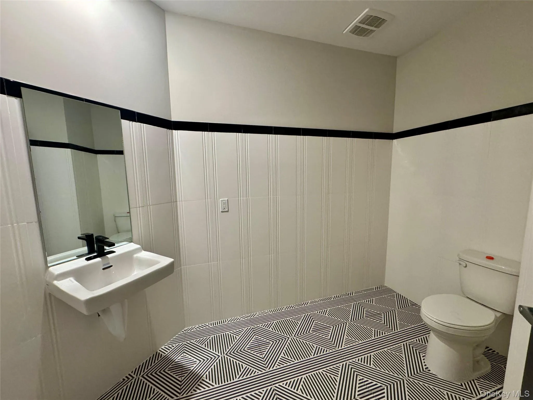 Bathroom with toilet and sink Bathroom with toilet and sink